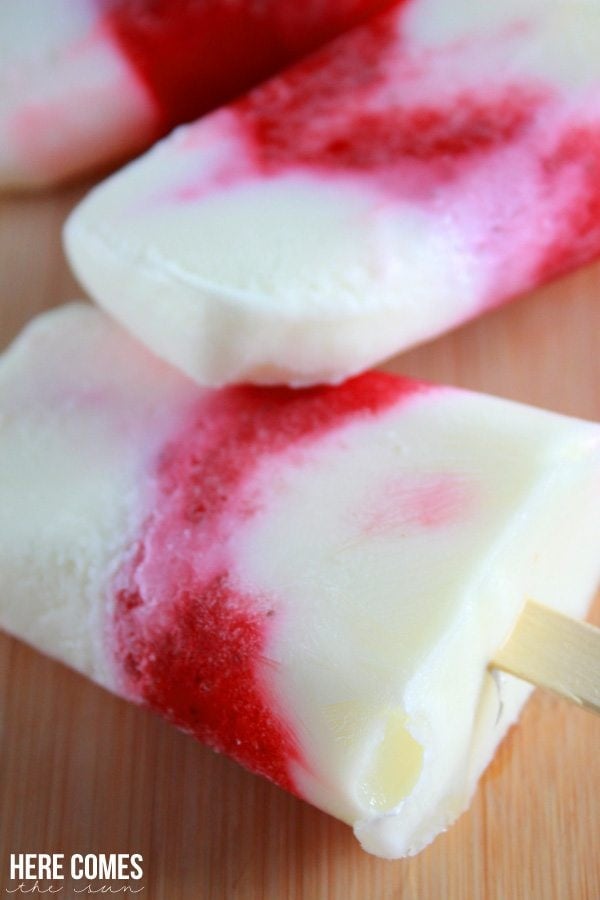 A close up of strawberry vanilla popsicles