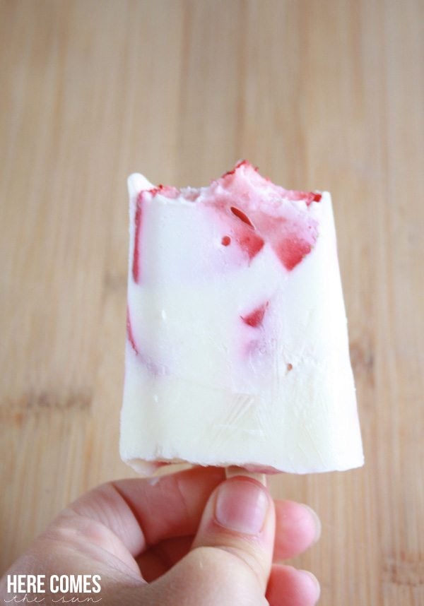 A close up of strawberry vanilla popsicles