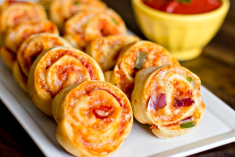 Pizza Pinwheels arranged on a white platte. 