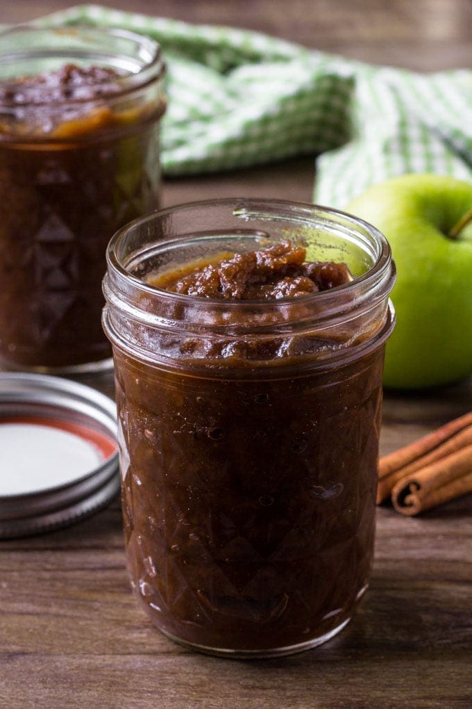 A jar filled with crockpot apple butter.