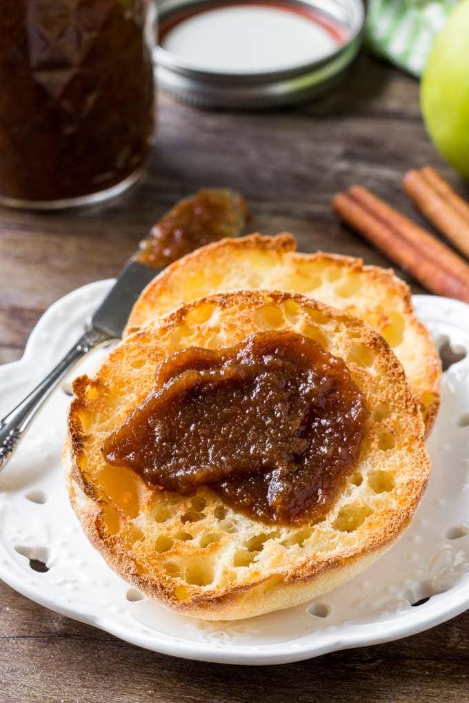 My Easy Crockpot Apple Butter Recipe is simple and cooks overnight in your crockpot! It's creamy and sweet and a healthier alternative to jams and jellies. Crocpot apple butter spread onto an english muffin.