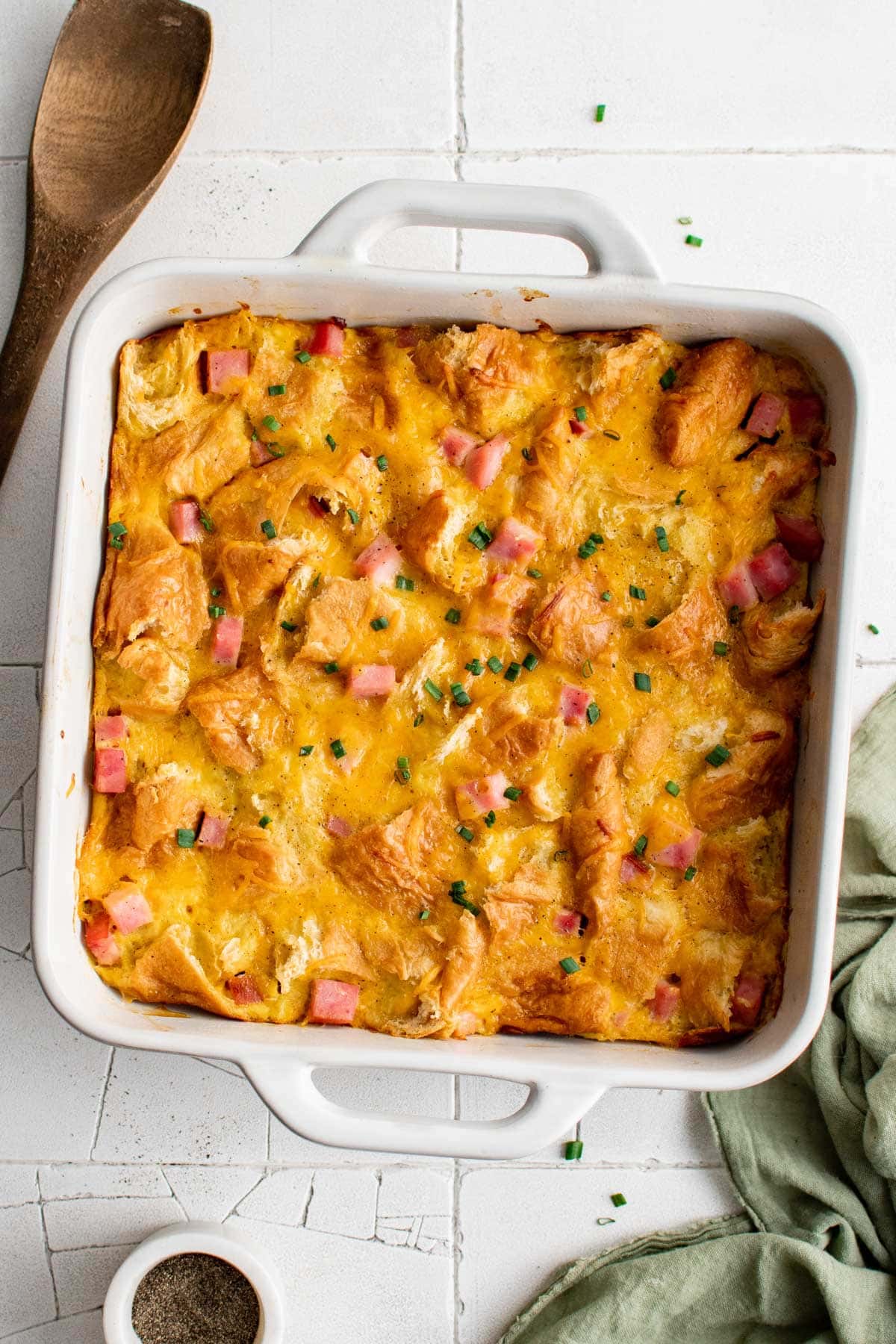 Breakfast casserole in a square white dish.
