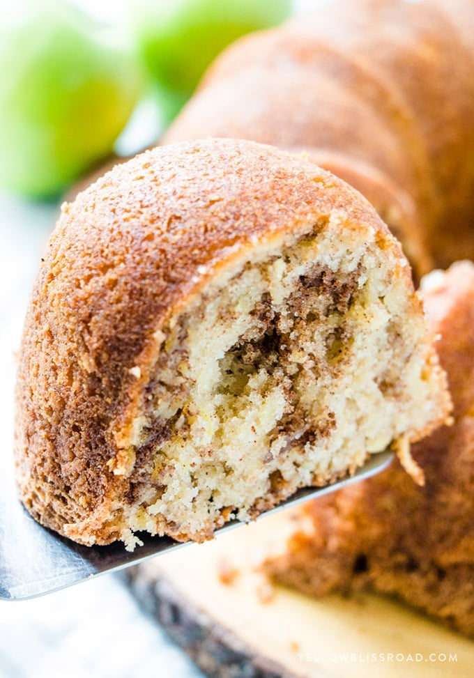 A slice of Cinnamon Apple Bundt Cake on a serving spatula.