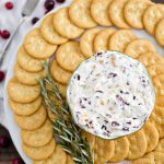 A plate of crackers and cheese spread