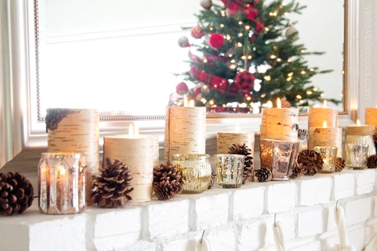 Gorgeous decorated Christmas mantel with pinecones, birch candles and mercury glass