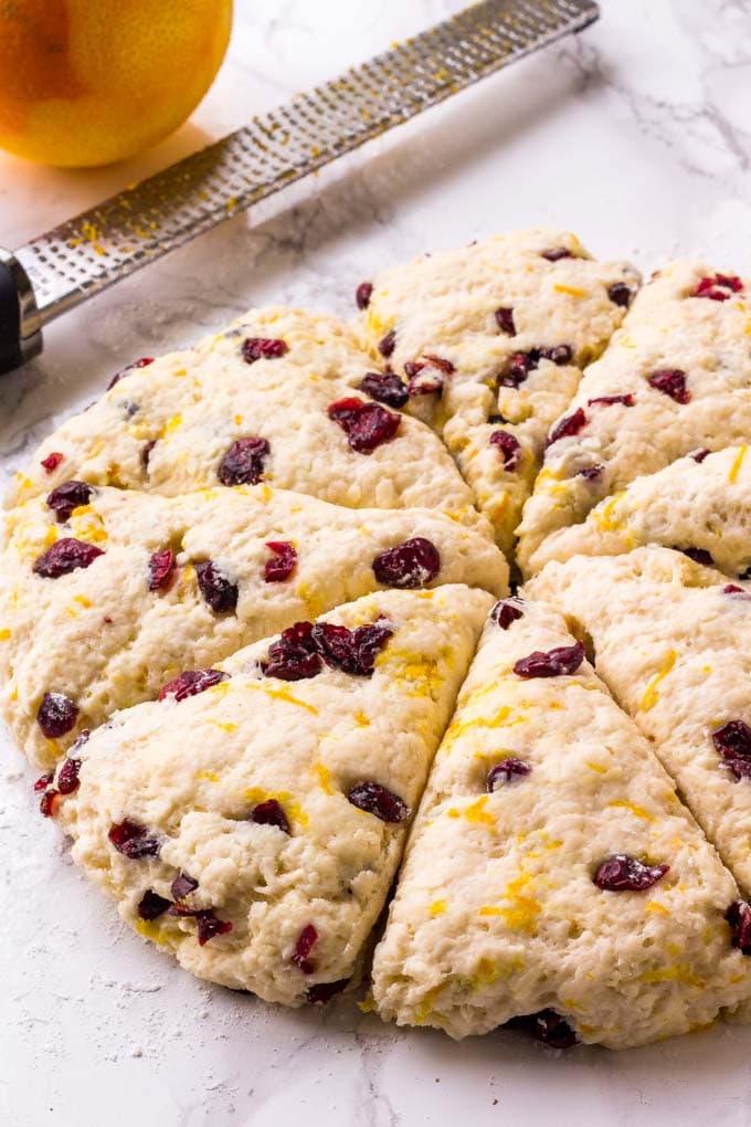 These Cranberry Orange Scones are buttery, tender and flaky with a creamy orange glaze, and they are the perfect breakfast for Christmas morning! Cranberry Orange Scone Dough for Christmas breakfast