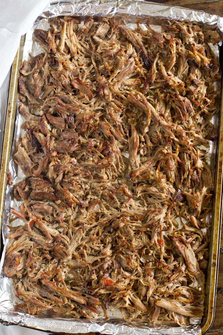 A sheet pan with shredded pork broiled to get crispy