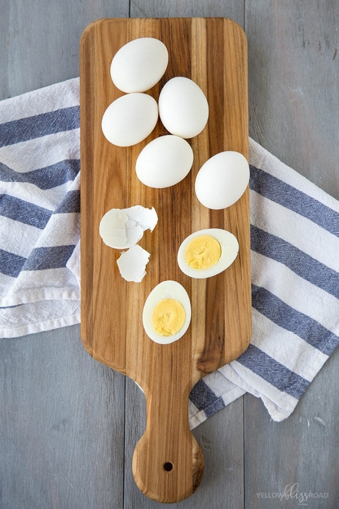 Hard boiled eggs on a wooden cutting board