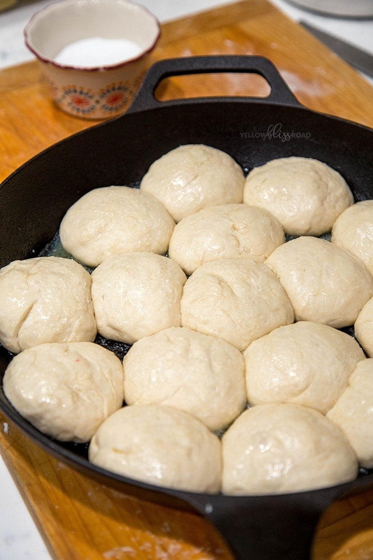 One Hour Dinner Rolls dough rising in a cast iron skillet.