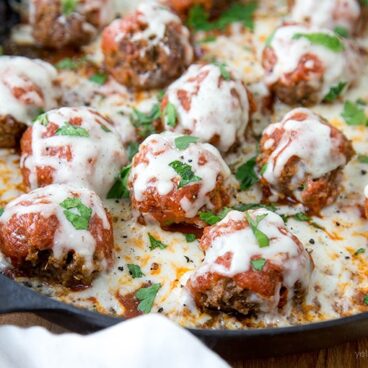 A close up of meatballs with parmesan