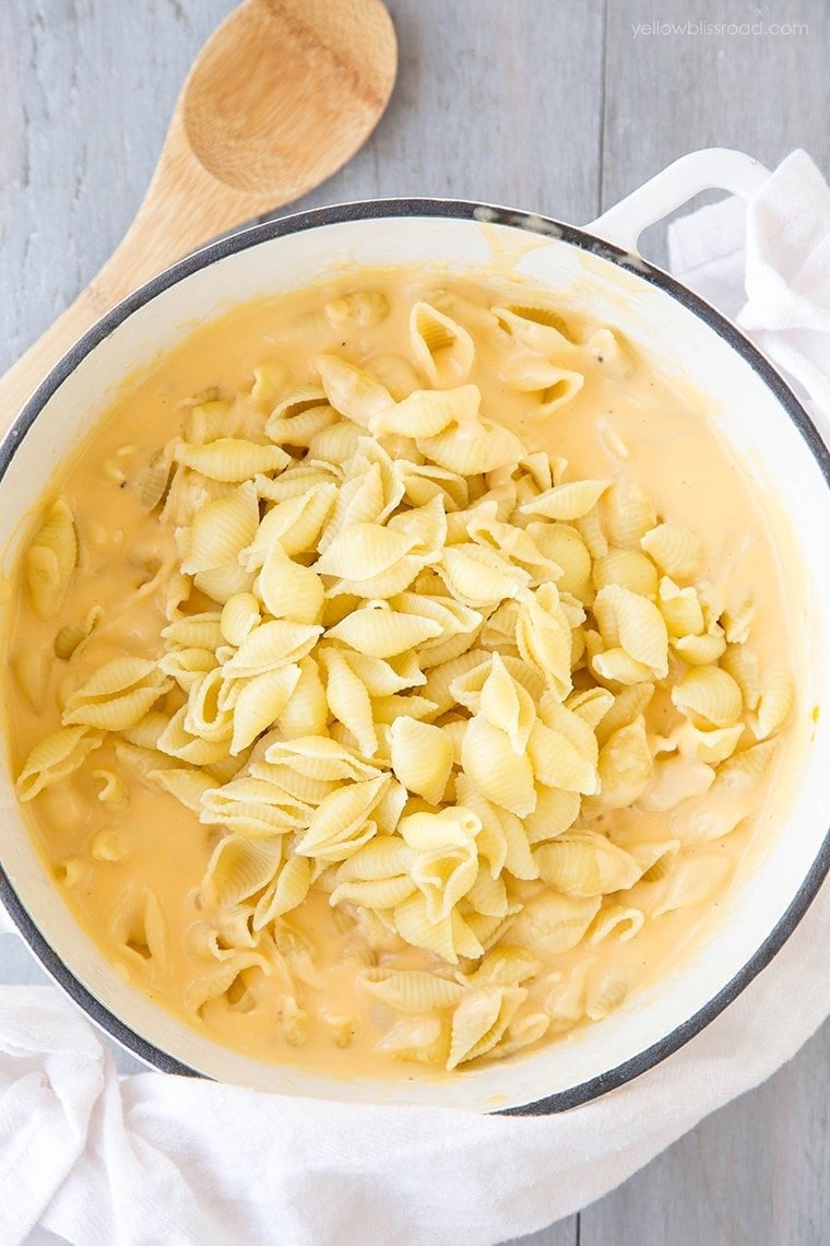 a large pot with shell pasta for stovetop mac and cheese
