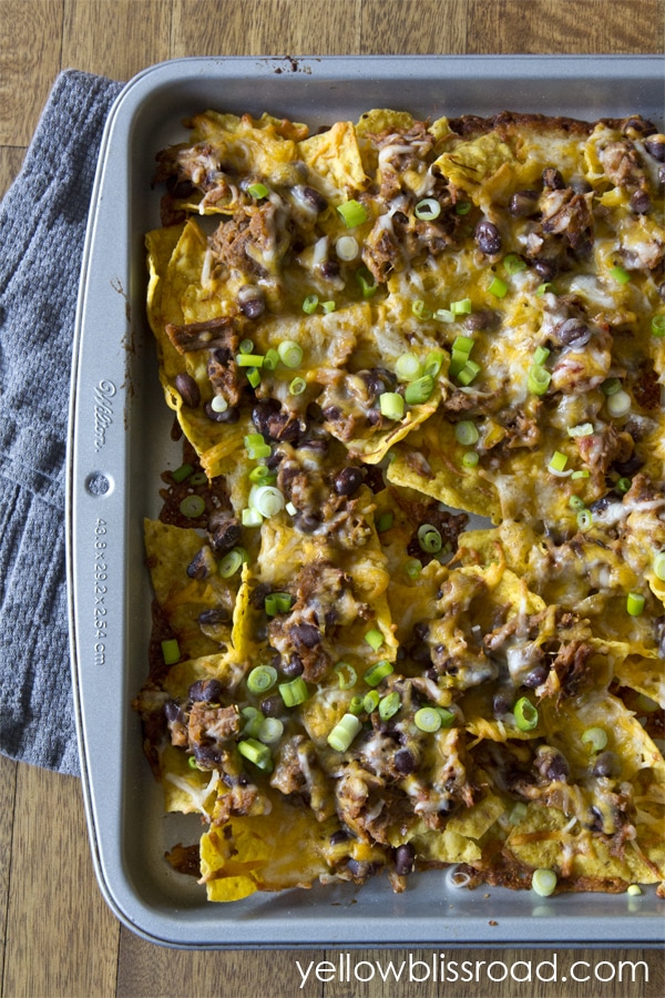 Shredded beef and black bean nachos! Create an easy Mexican meal or snack with just a minutes and a few ingredients. The perfect snack for Cinco de Mayo!!