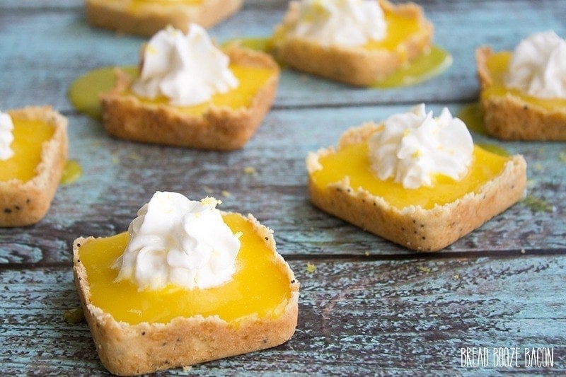 Mini Lemon Tarts - Mini Shortbread shells hold a tart and sweet lemon curd. It's the perfect spring dessert!