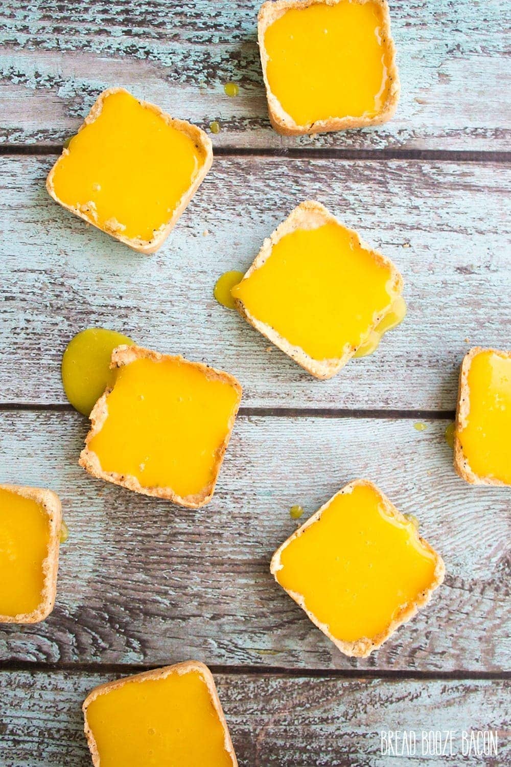 Mini Lemon Tarts - Mini Shortbread shells hold a tart and sweet lemon curd. It's the perfect spring dessert!