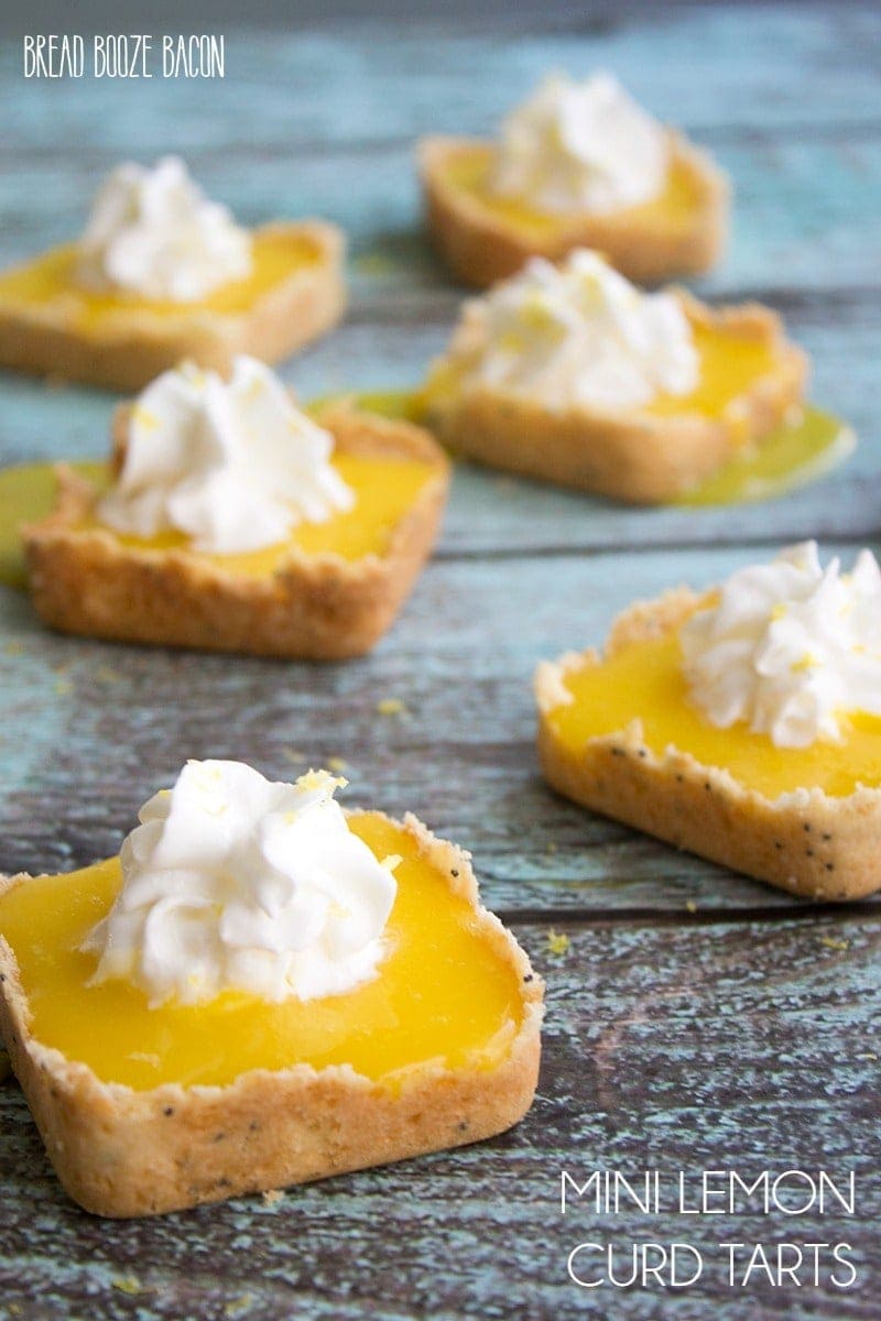 Mini Lemon Tarts - Mini Shortbread shells hold a tart and sweet lemon curd. It's the perfect spring dessert!