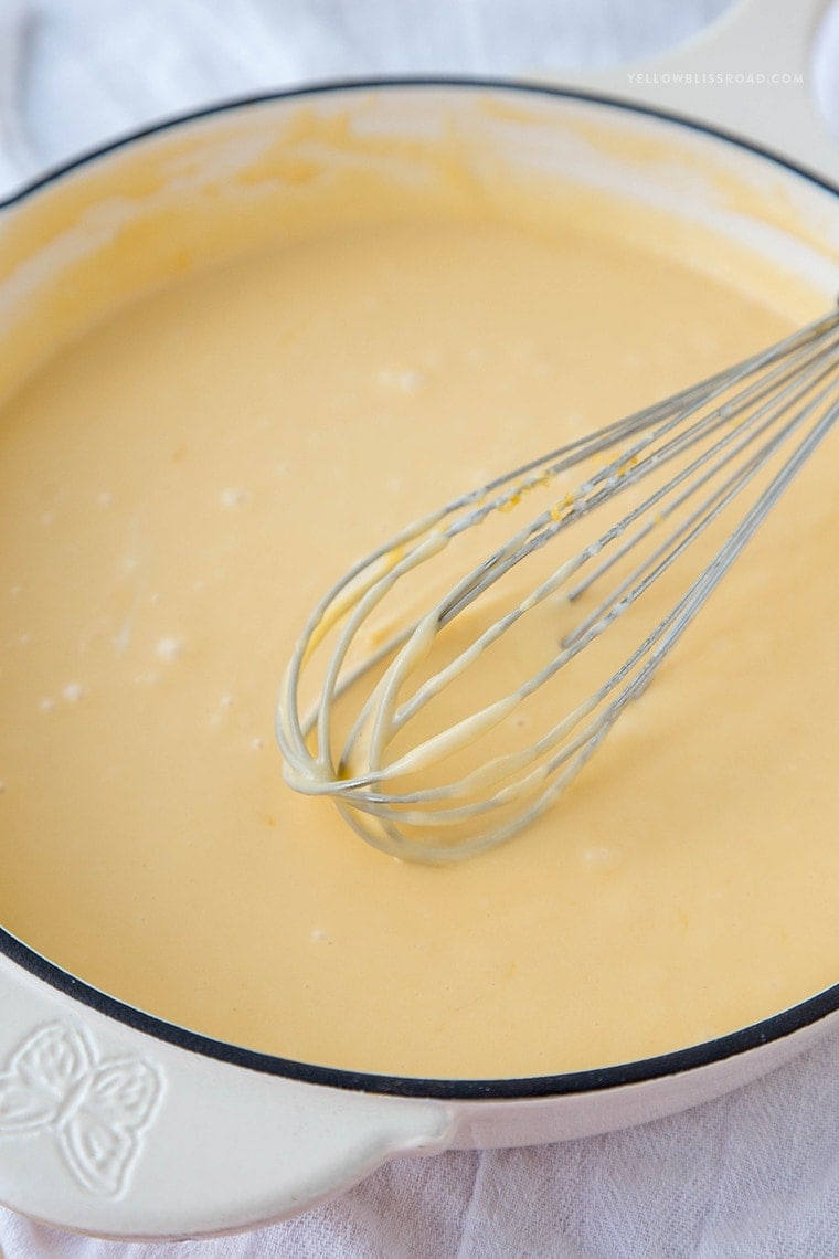 cheese sauce in a large pot with whisk
