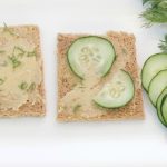 A close up of Hummus and Cucumbers on bread