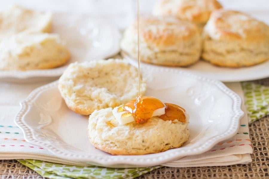 Biscuit on a plate with butter and honey