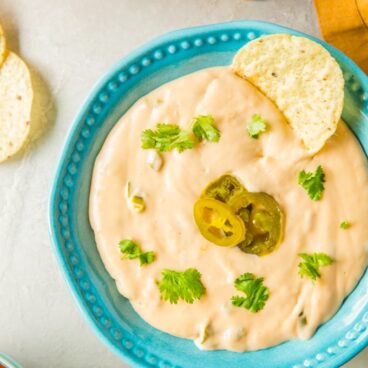 A dish filled with Nacho Cheese dip