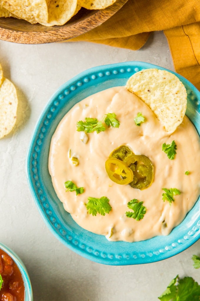 A dish filled with Nacho Cheese dip