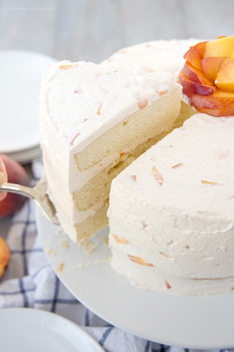 Vanilla Peach Layer Cake is a perfect dessert for summer. Tender, moist cake is layered with a sweet peaches and cream frosting, with chunks of fresh peaches.