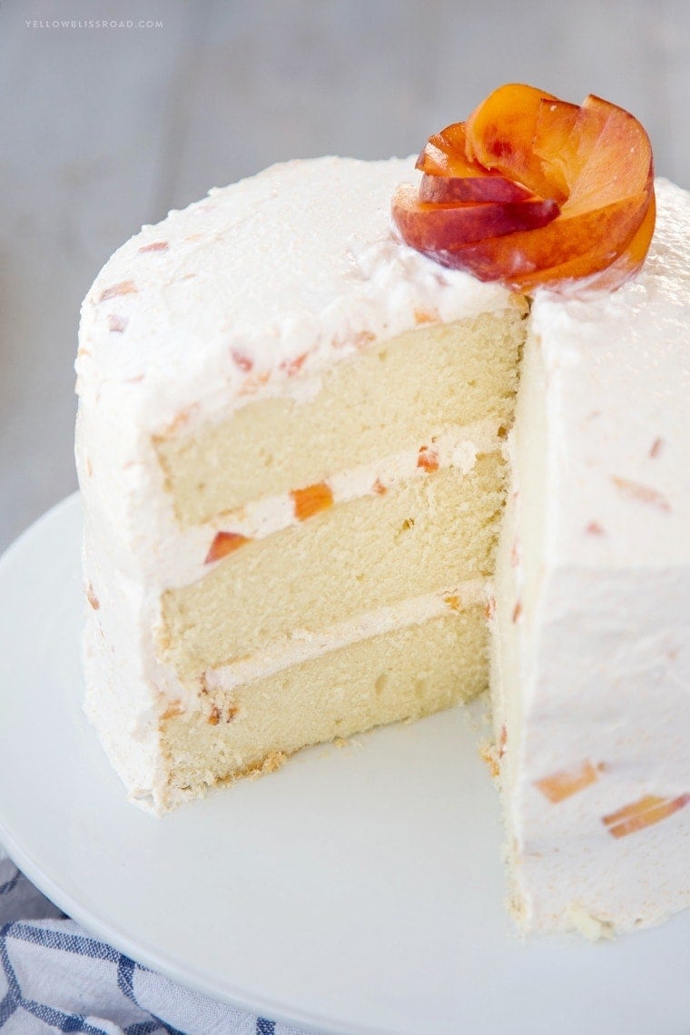 Vanilla Peach Layer Cake is a perfect dessert for summer. Tender, moist cake is layered with a sweet peaches and cream frosting, with chunks of fresh peaches.