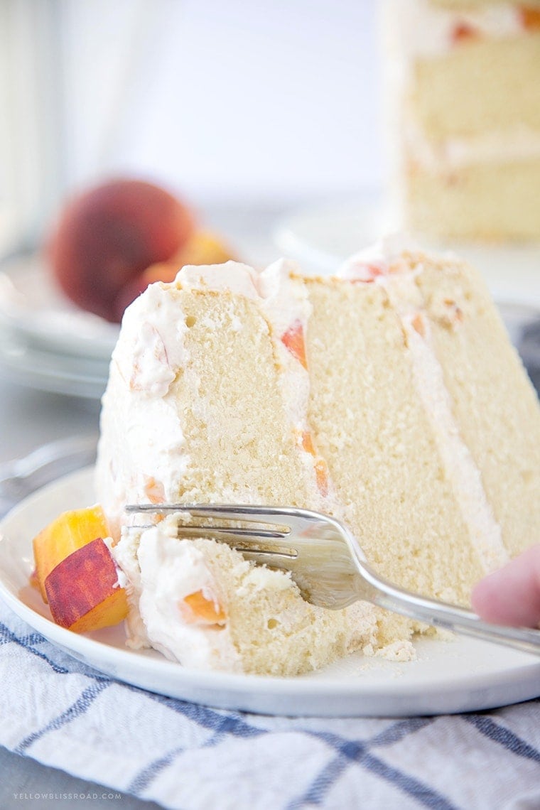 Vanilla Peach Layer Cake is a perfect dessert for summer. Tender, moist cake is layered with a sweet peaches and cream frosting, with chunks of fresh peaches.