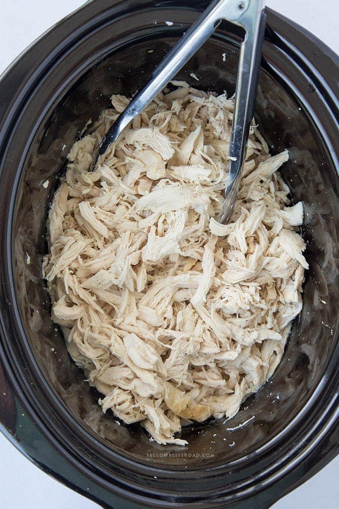 Easy and All-Purpose Shredded Chicken made in the slow cooker. Freeze in portions to use in all your favorite recipes! Flavorful, tender and juicy every time.