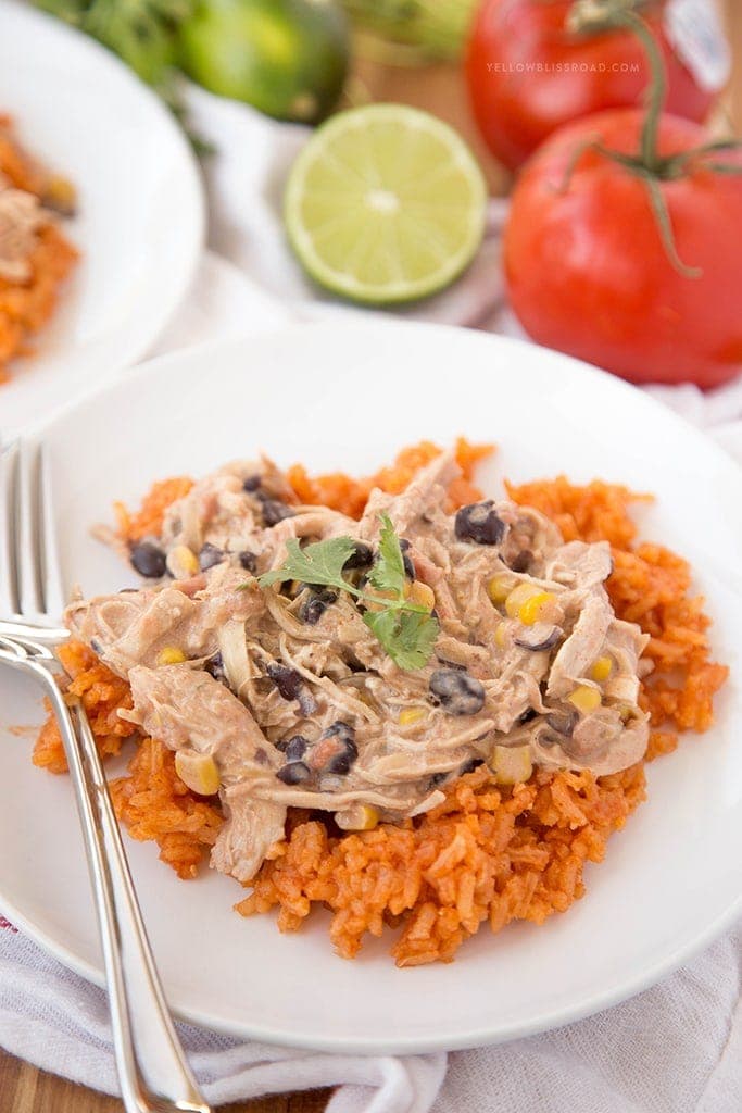 Slow Cooker Creamy Fiesta Chicken on a bed of rice on a plate.