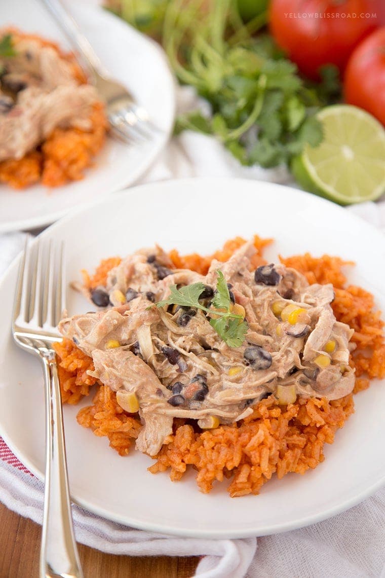 A close up of taco ranch chicken over a bed of mexican rice.