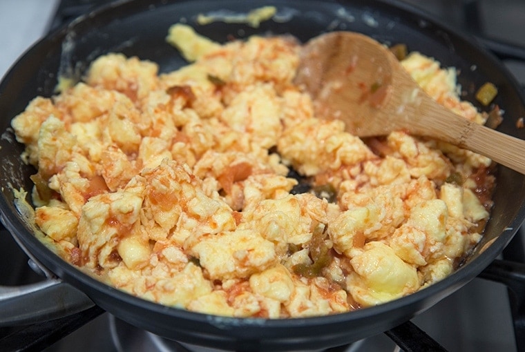Scrambled eggs and salsa in a pan