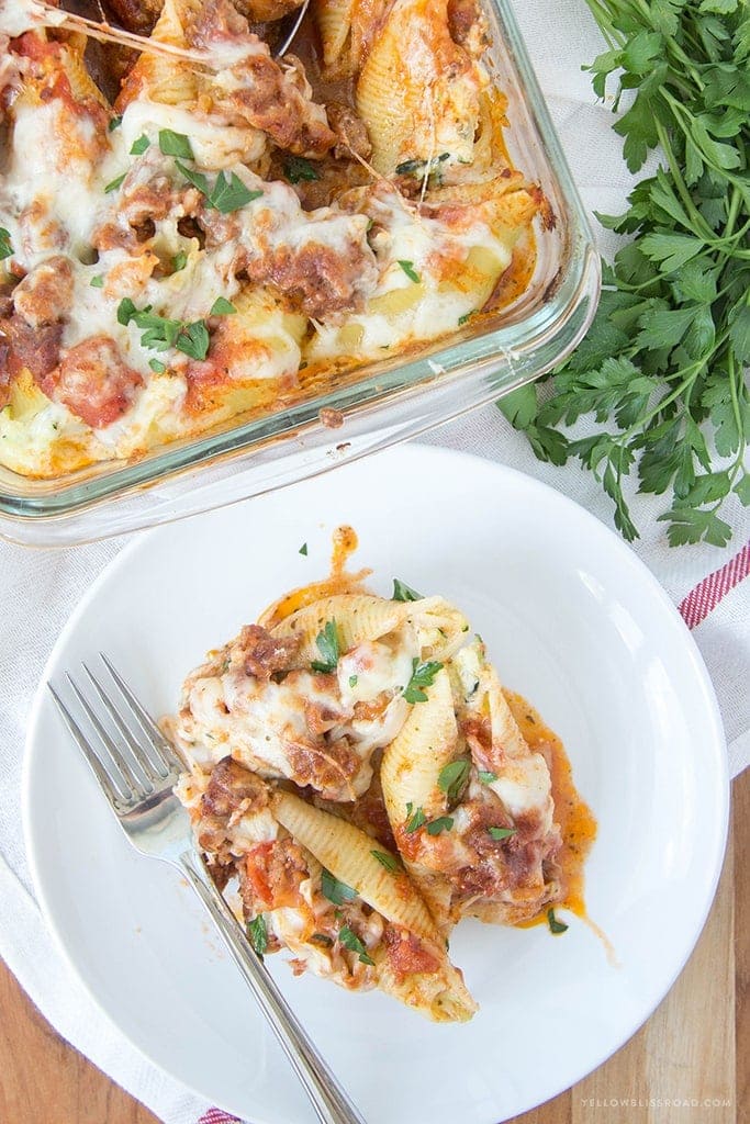 Zucchini Stuffed Shells with Sausage - Tender pasta shells filled with Ricotta and mozzarella cheese and shredded zucchini. Smothered in a rich sausage marinara. Such an elegant weeknight dinner!