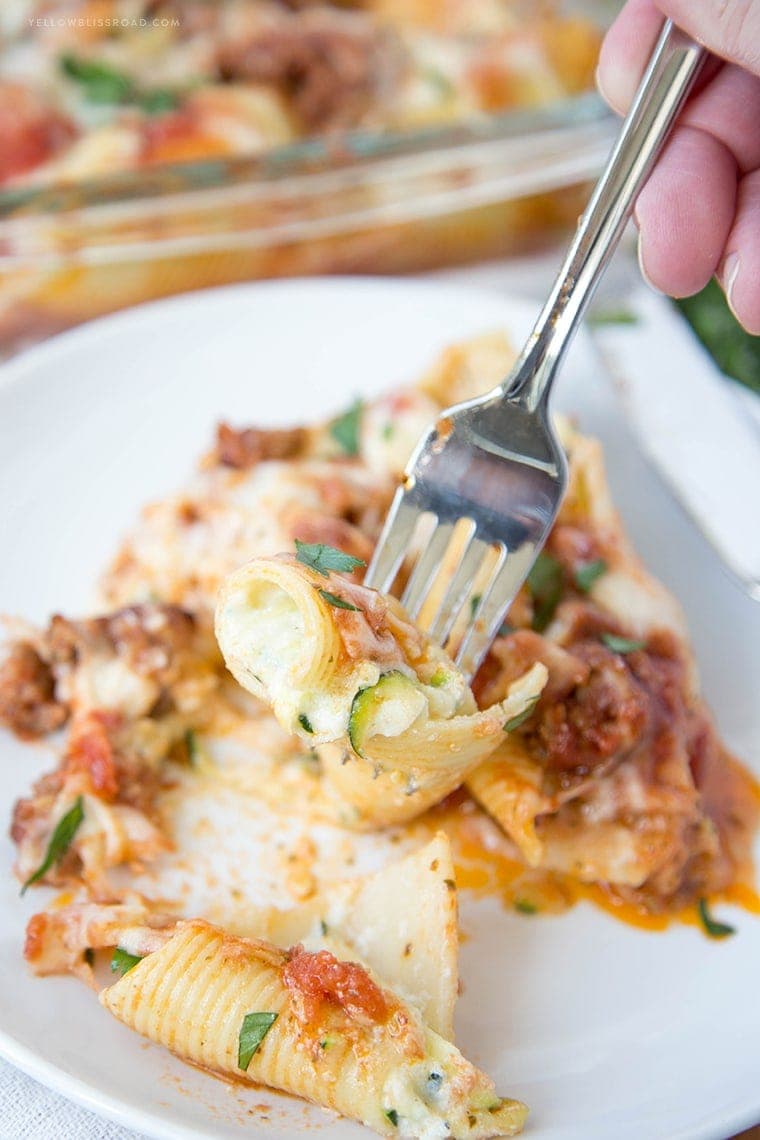 Zucchini Stuffed Shells with Sausage - Tender pasta shells filled with Ricotta and mozzarella cheese and shredded zucchini. Smothered in a rich sausage marinara. Such an elegant weeknight dinner!