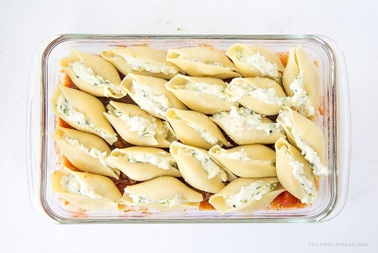 Zucchini Stuffed Shells with Sausage - Tender pasta shells filled with Ricotta and mozzarella cheese and shredded zucchini. Smothered in a rich sausage marinara. Such an elegant weeknight dinner!