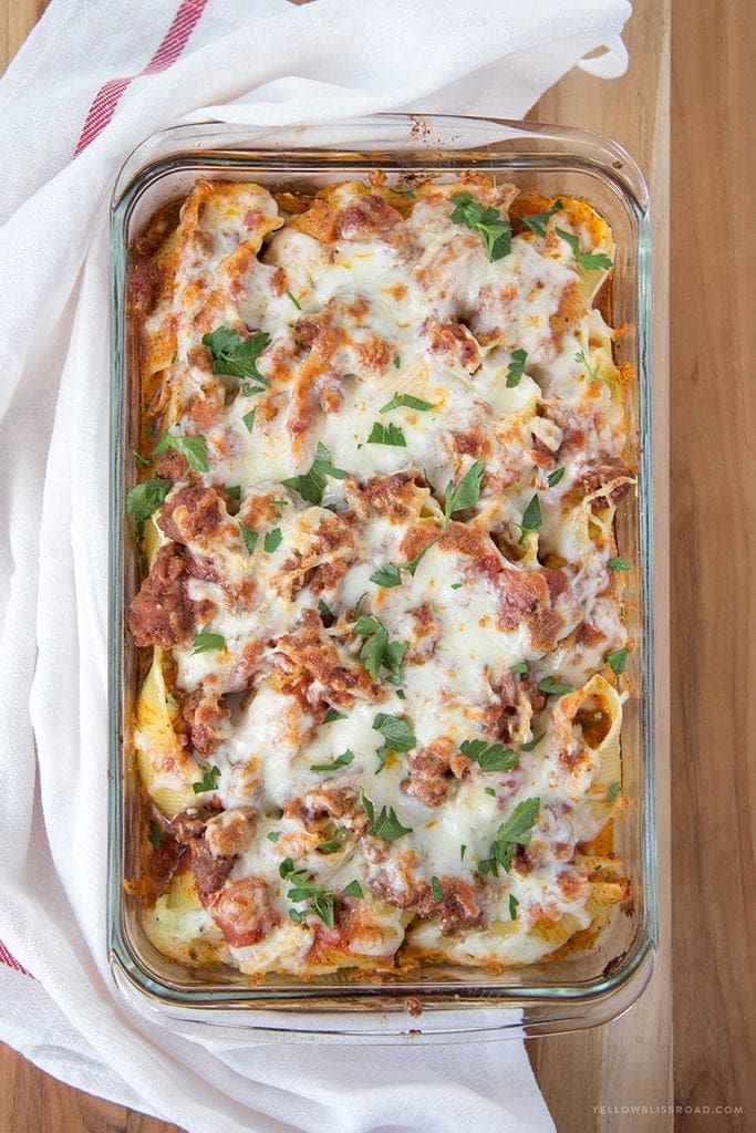 Zucchini Stuffed Shells with Sausage - Tender pasta shells filled with Ricotta and mozzarella cheese and shredded zucchini. Smothered in a rich sausage marinara. Such an elegant weeknight dinner!