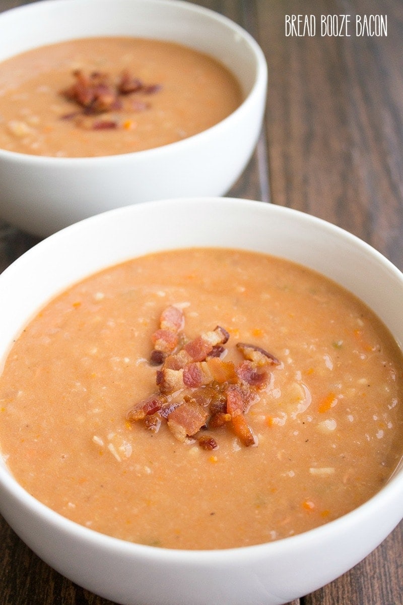 2 bowls of bacon and bean soup with chopped bacon garnish.