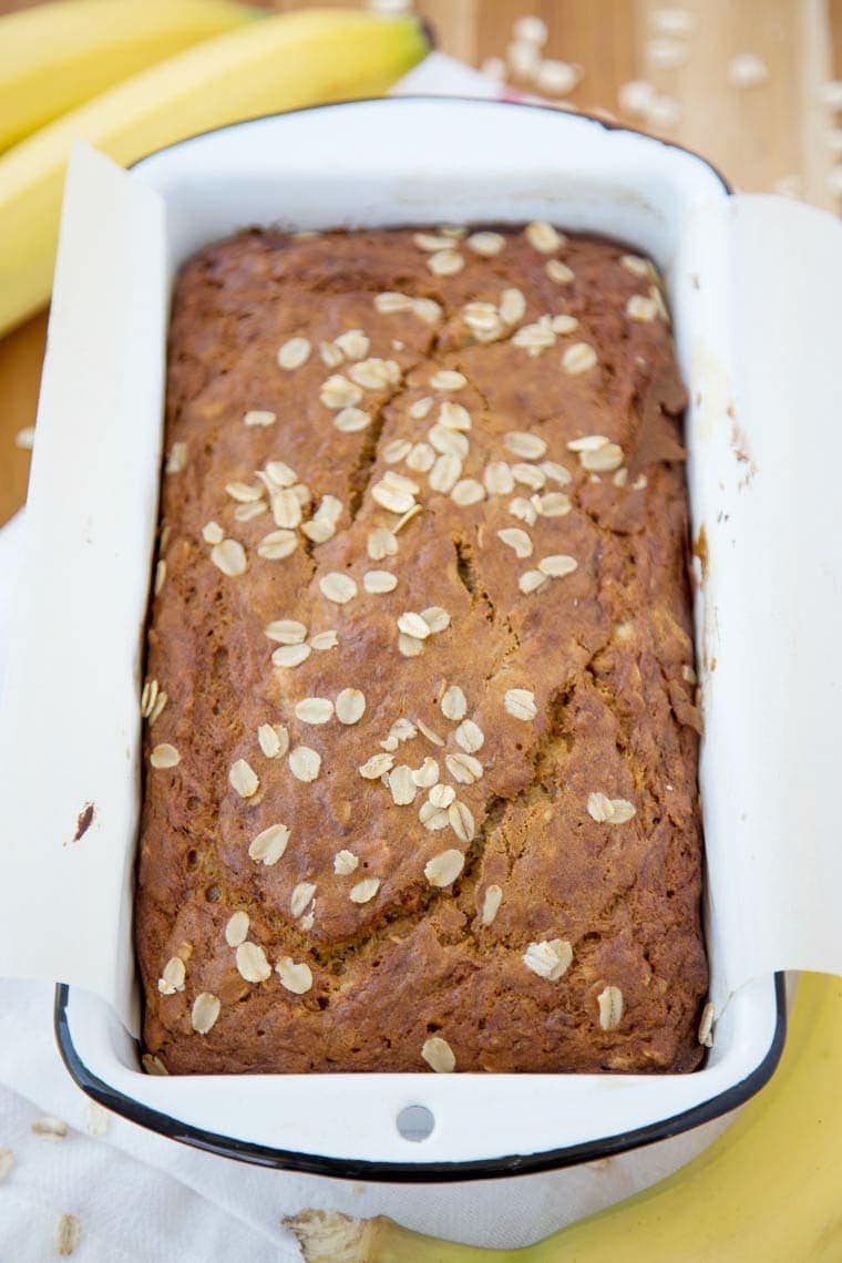 Vanilla Oatmeal Banana Bread - Made lighter with Greek Yogurt and less sugar. Perfect for an after school snack, quick breakfast or even as muffins!