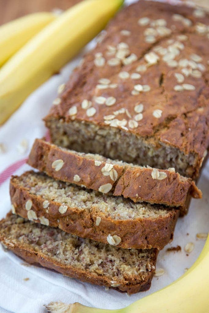 Vanilla Oatmeal Banana Bread - Made lighter with Greek Yogurt and less sugar. Perfect for an after school snack, quick breakfast or even as muffins!