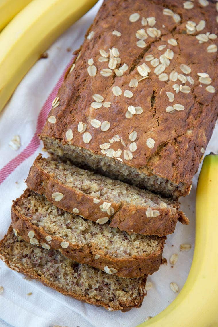 Vanilla Oatmeal Banana Bread - Made lighter with Greek Yogurt and less sugar. Perfect for an after school snack, quick breakfast or even as muffins!