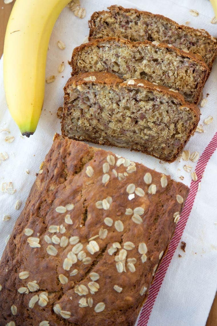 Vanilla Oatmeal Banana Bread - Made lighter with Greek Yogurt and less sugar. Perfect for an after school snack, quick breakfast or even as muffins!