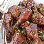 A plate of bbq chicken drumsticks