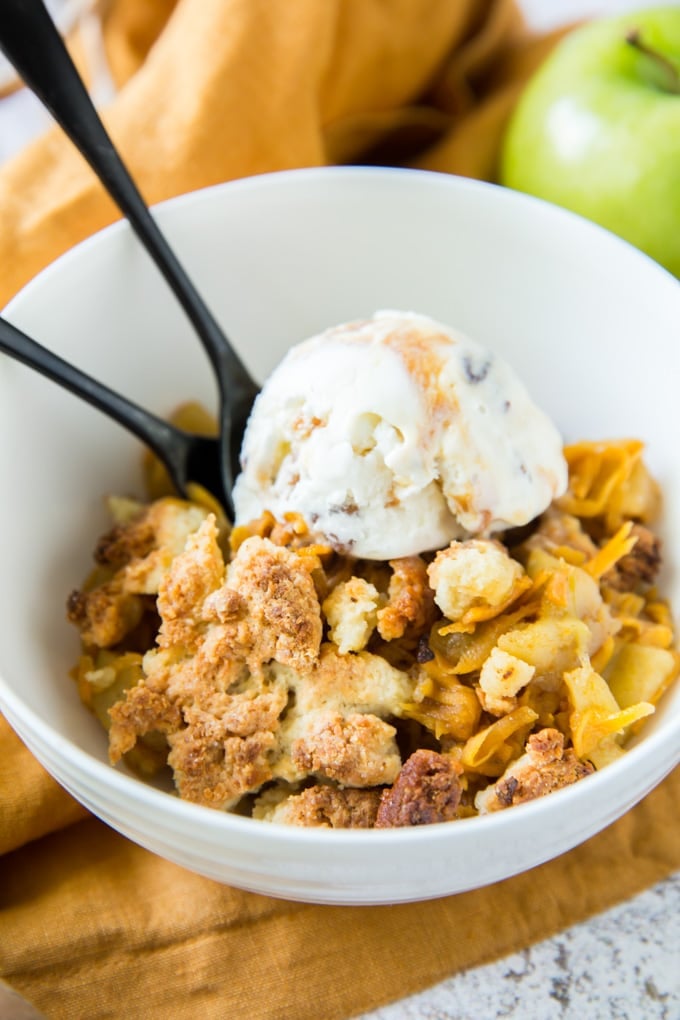 A bowl of apple cobbler with ice cream