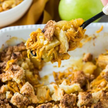 A casserole dish filled with sweet potato and apple cobbler