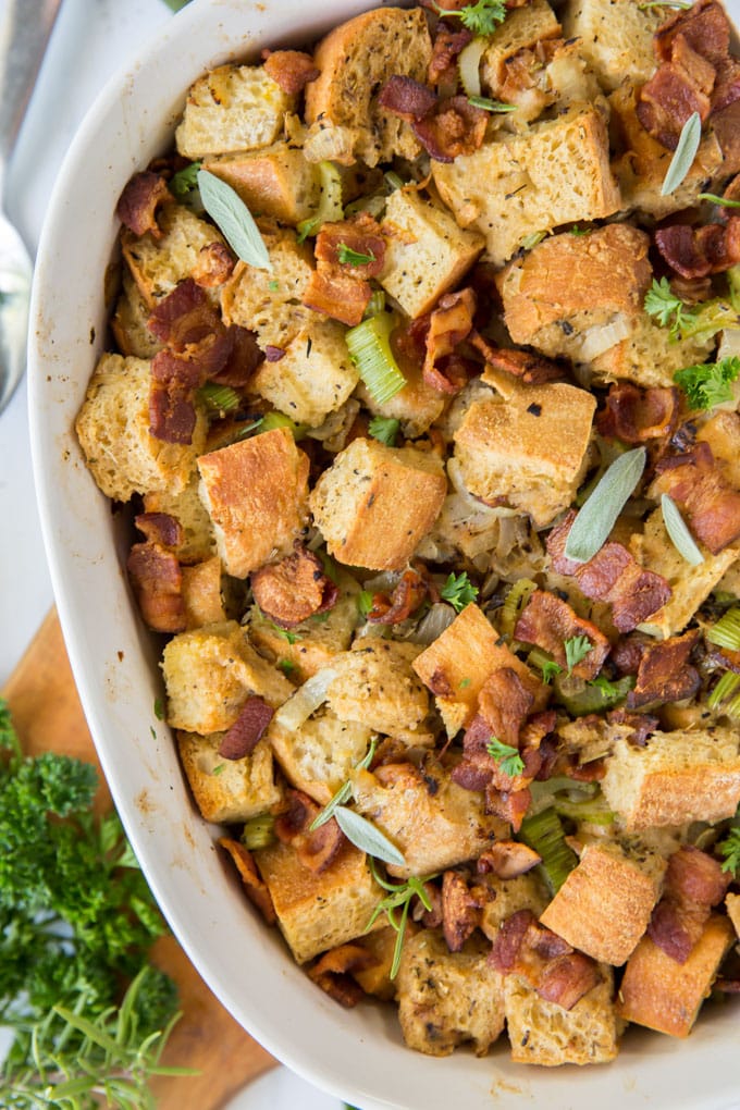 close up overhead of bacon stuffing in a white casserole dish