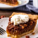 A piece of Pecan pie with whipped cream