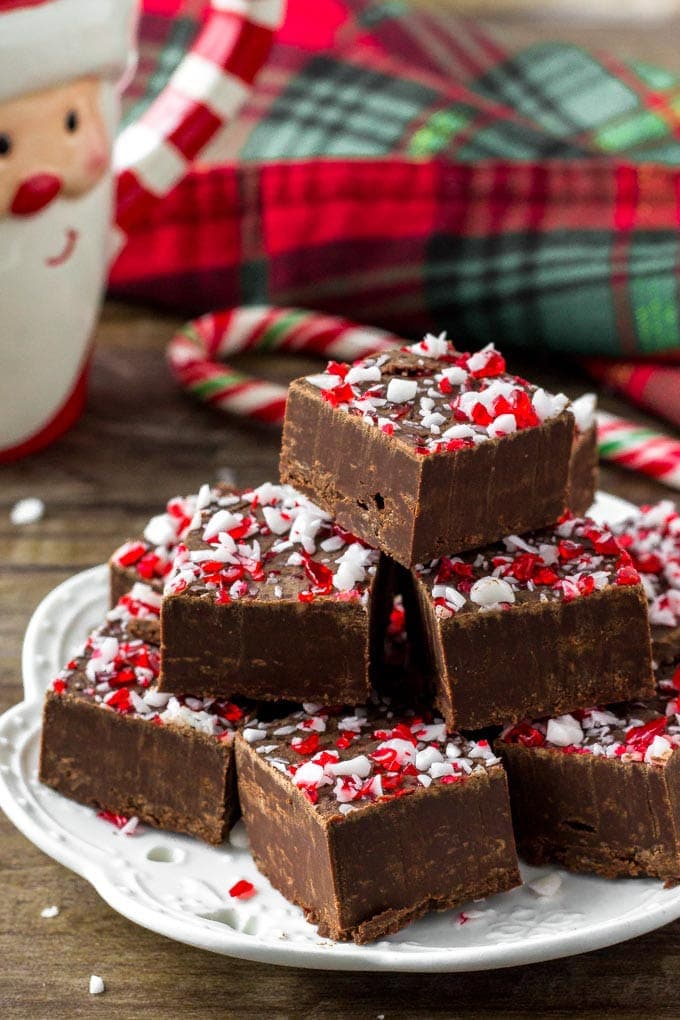 A stack of peppermint fudge squares on a white plate.