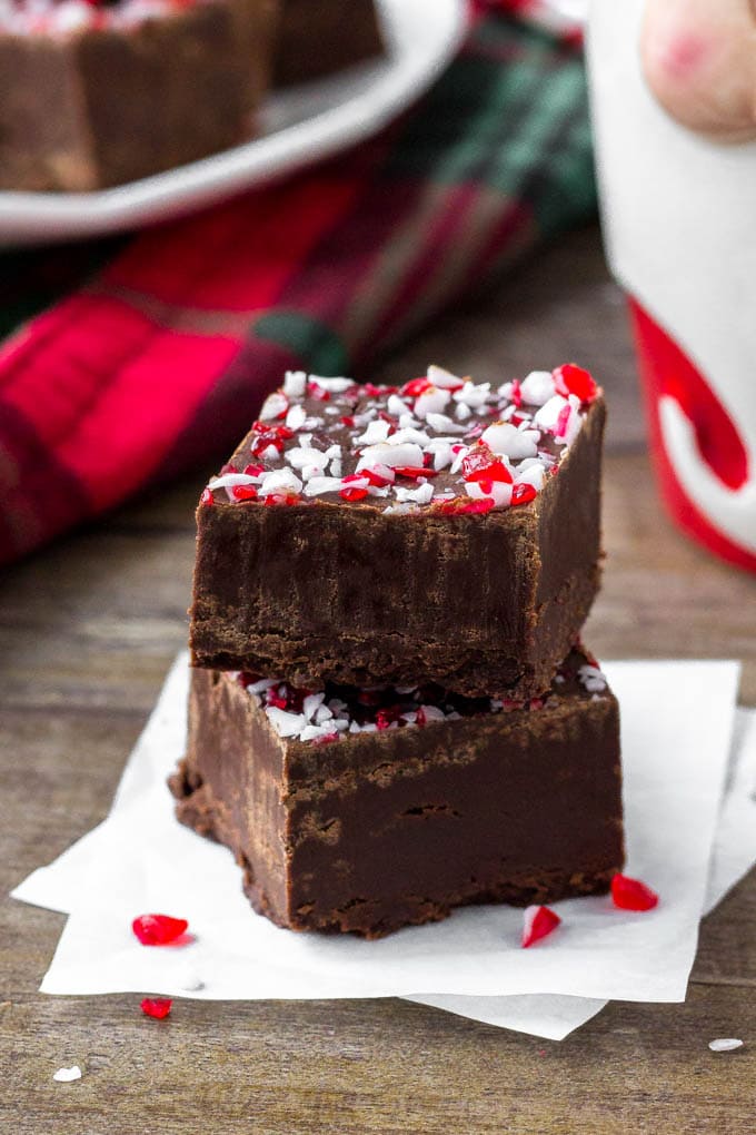 Two pieces of chocolate peppermint fudge with crushed candy canes.