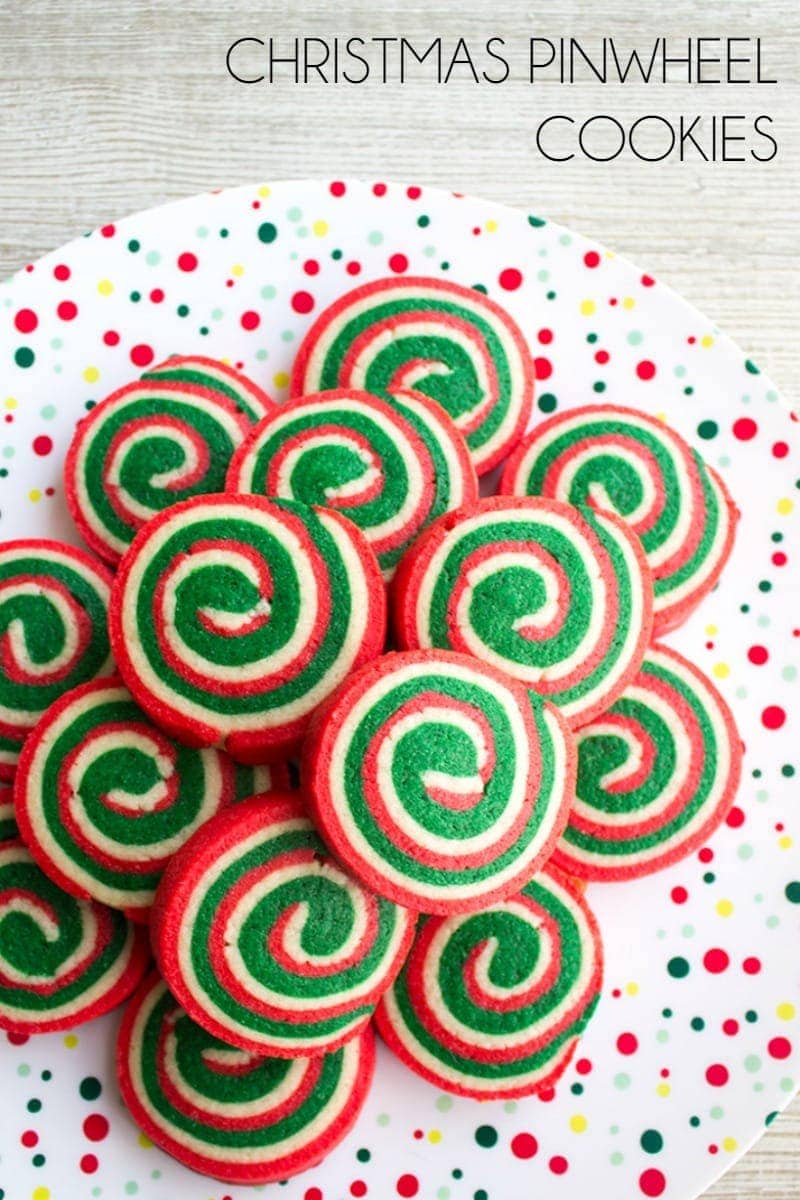 A stack of christmas pinwheel cookies on a plate. Text on the image states the title of the recipe.