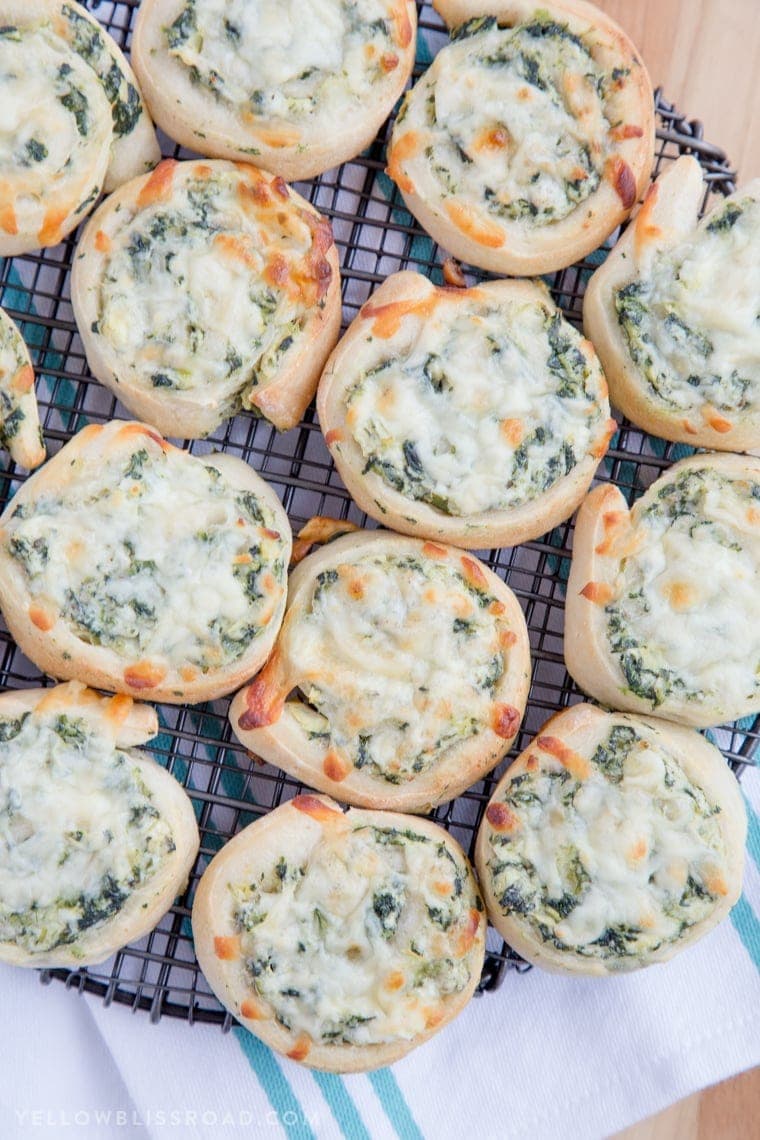 Spinach Artichoke Pinwheels on a baking rack