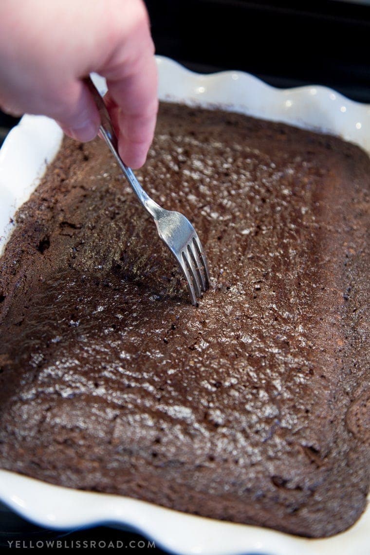 Chocolate Coconut Cream Poke Cake - Rich chocolate cake, coconut cream filling and fluffy, creamy frosting. A rich and decadent dessert!